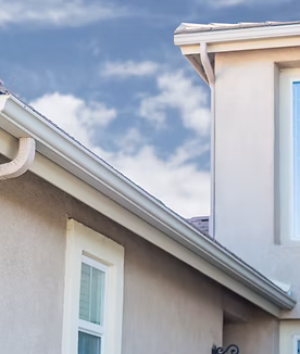 Seamless aluminum gutter system with downspout on Dayton Ohio home protecting fascia and eaves
