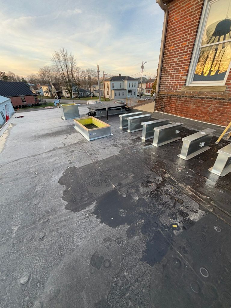 Metal roof exhaust vents and flashing systems installation for enhanced roofing performance.