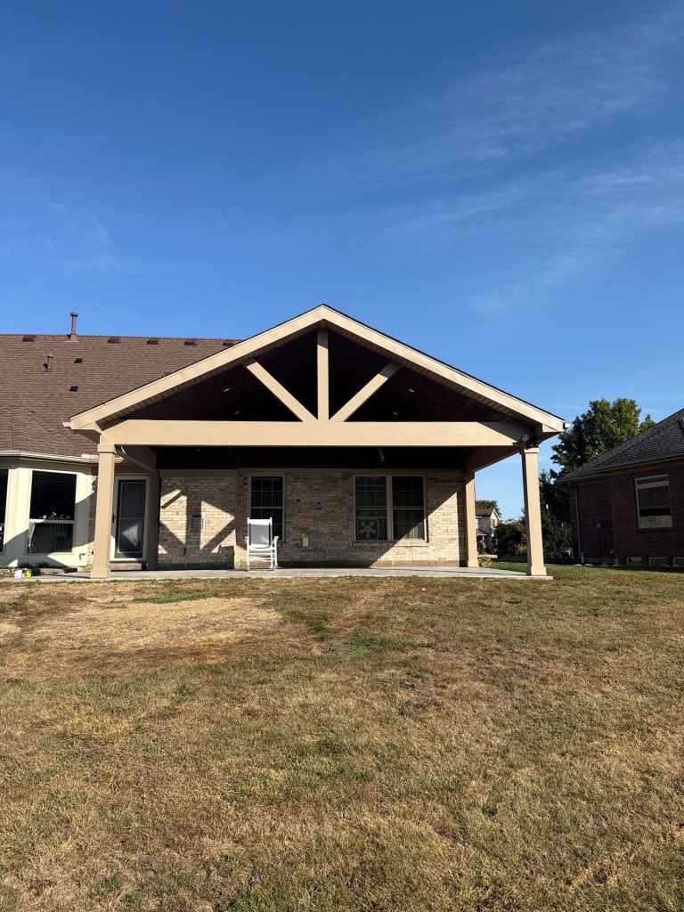 Modern house with durable roofing and siding, featuring an attractive covered patio, showcasing home exterior renovation, quality roofing materials, and siding installation for curb appeal.