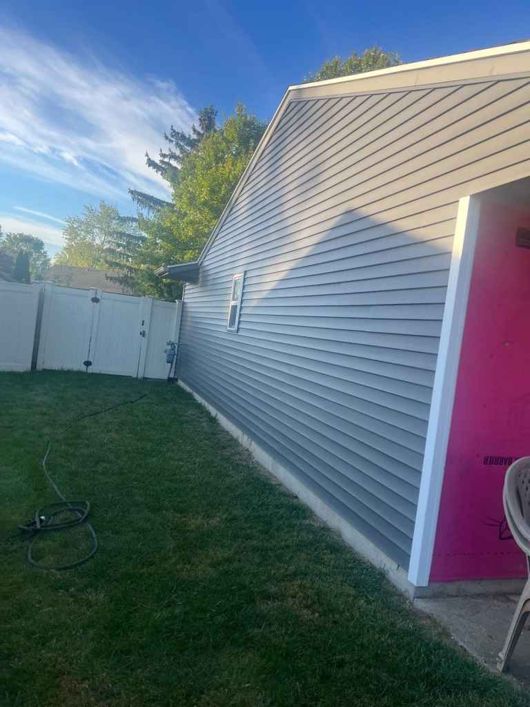 Newly installed vinyl siding on home exterior enhances curb appeal and protects against weather. Professional siding installation by Elevated Roofing and Siding ensures durability and aesthetic value.