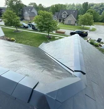 New roof installation with durable metal roofing panels at a residential home, showcasing professional roofing services by Elevated Roofing and Siding.