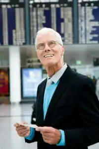 Older man holding ticket