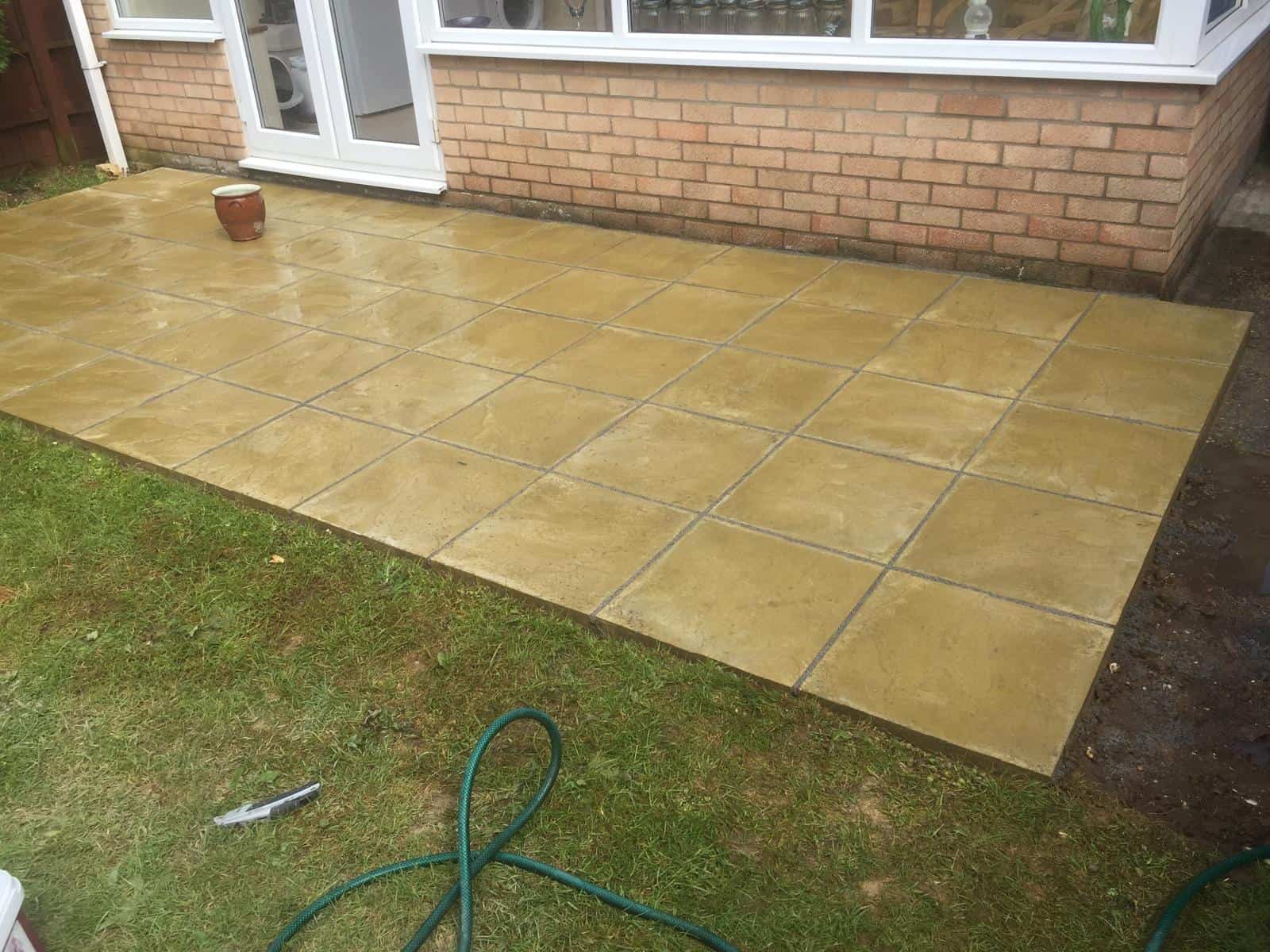 Newly laid patio with large paving slabs outside a house in Suffolk.