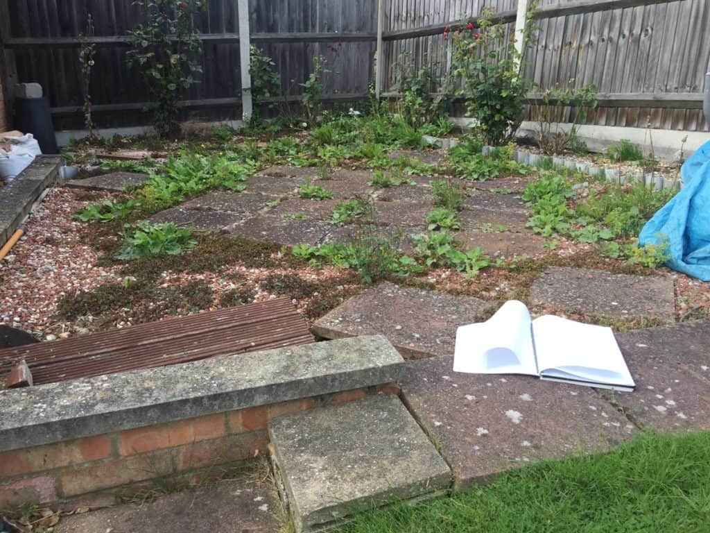 Backyard garden with new fencing and planting beds in Suffolk.