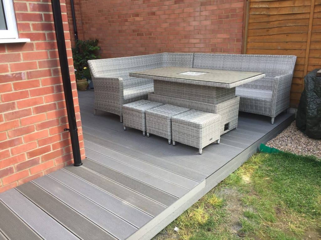 Modern composite decking with outdoor garden seating area.