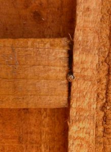 Close-up of wooden fence panel showing wood grain and joint.