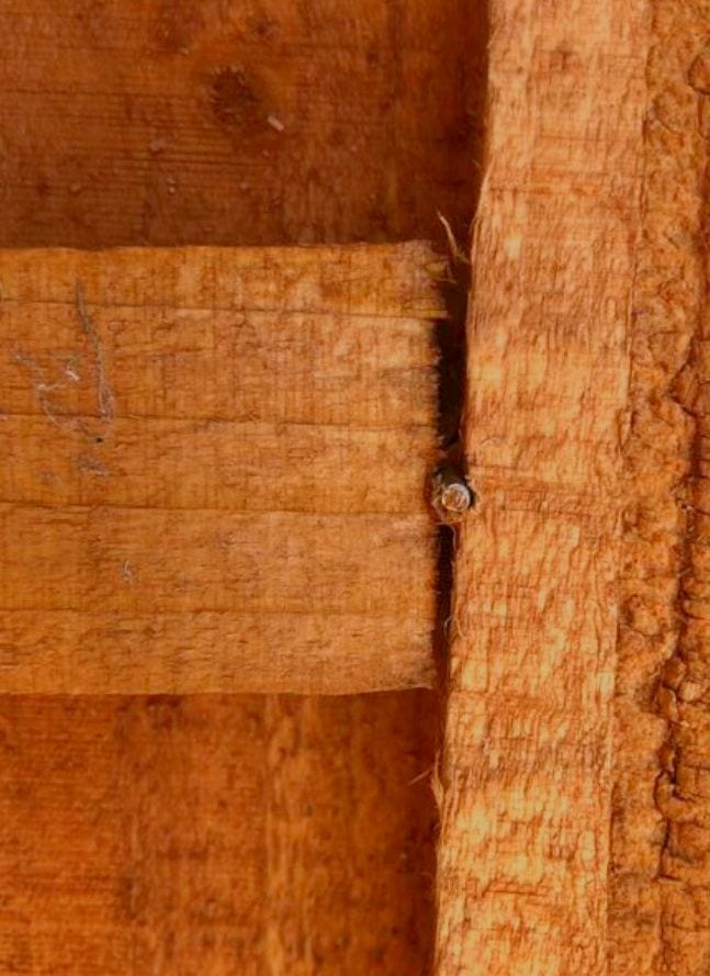 Close-up of wooden fence panel showing wood grain and joint.