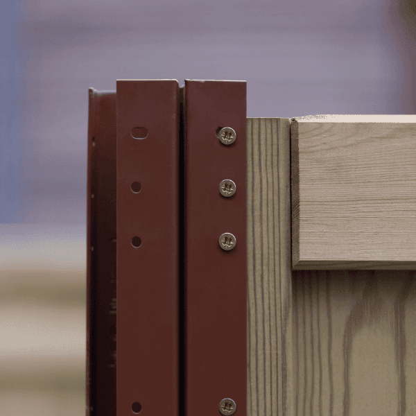 Close-up of Durapost fencing with metal brackets and wooden panels.