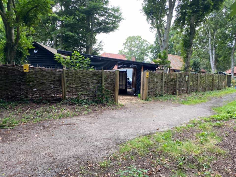 Durapost fencing installed in a garden with trees and a gravel path.