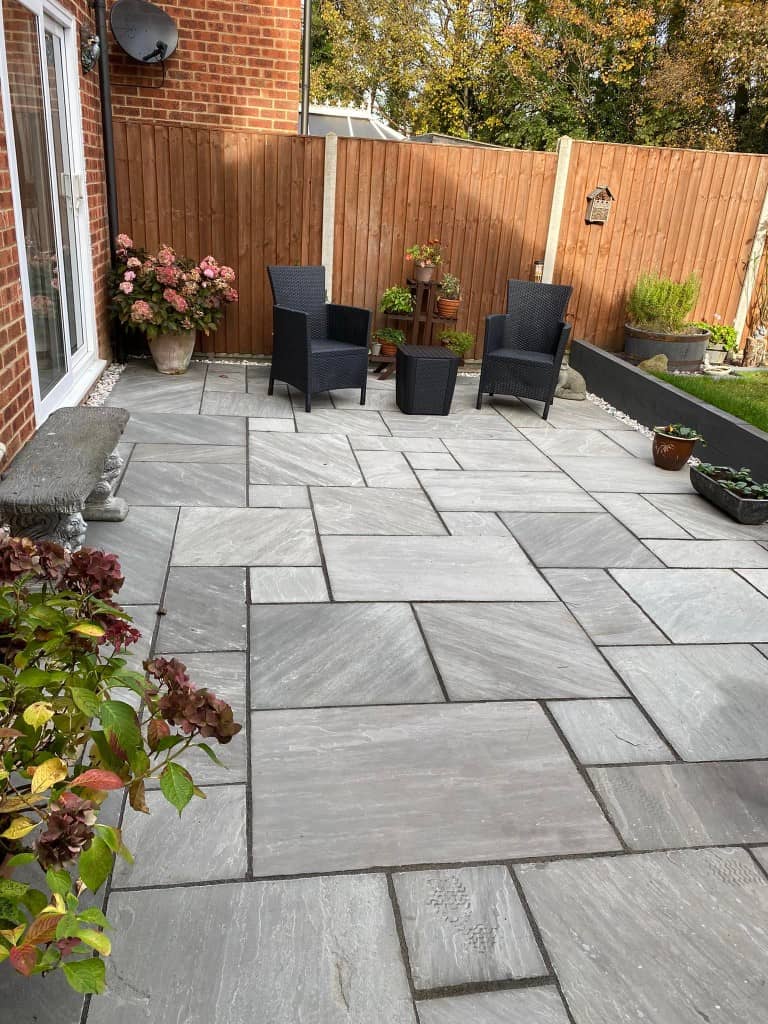 Contemporary outdoor patio with seating and potted plants.