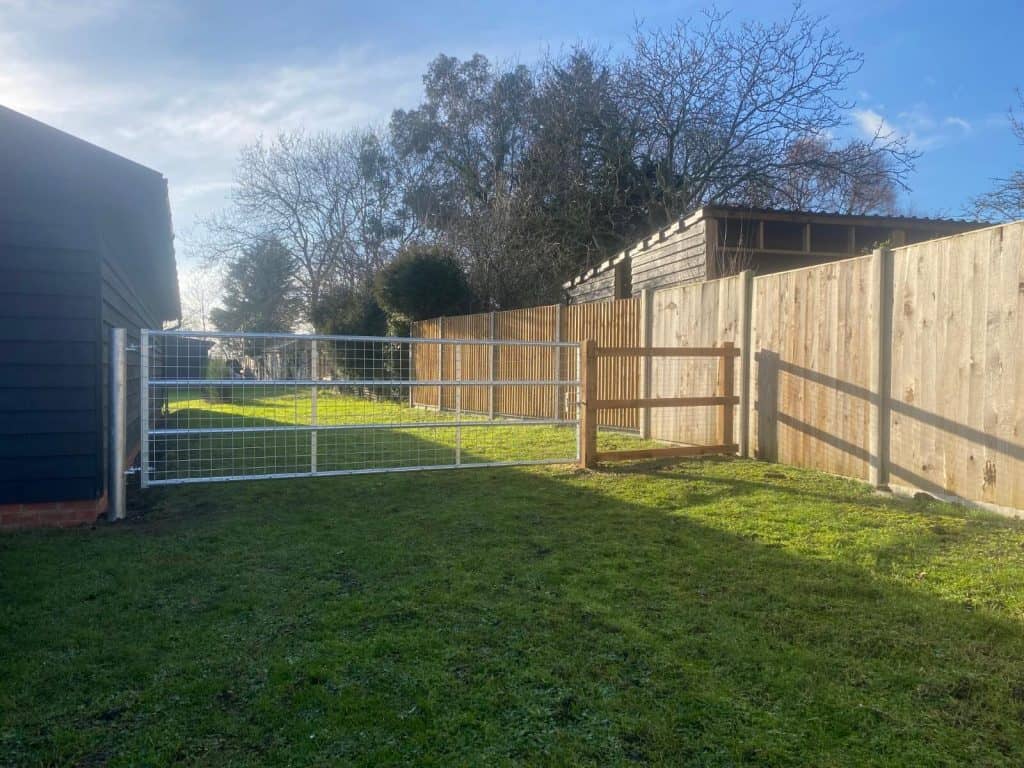 New wooden and metal garden fencing installed for privacy and security.