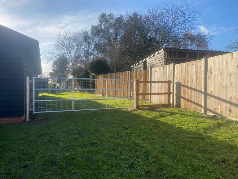 New wooden and metal garden fencing installed for privacy and security.
