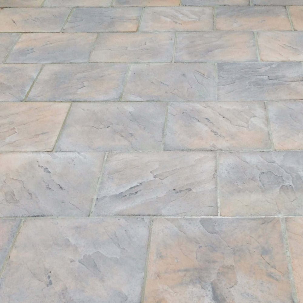 Close-up of a newly laid stone patio in a garden setting.