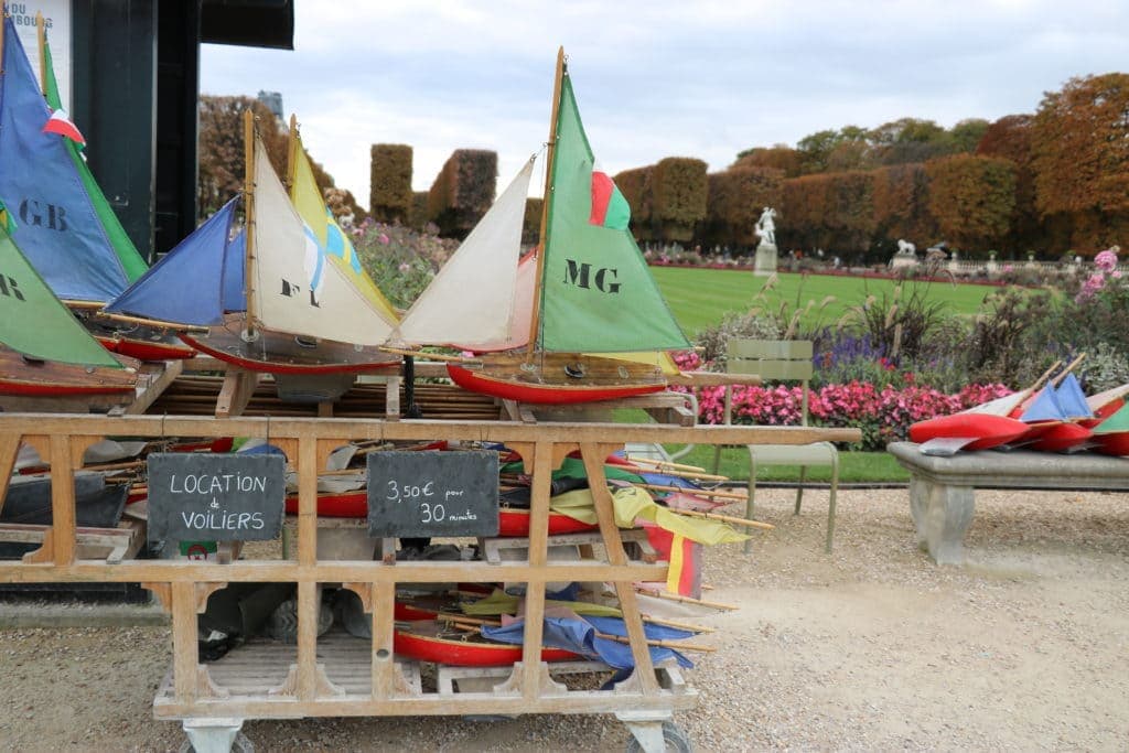 A stand of coloured wooden toy boats for hire to sail on the pond in the Jardin du Luxembourg