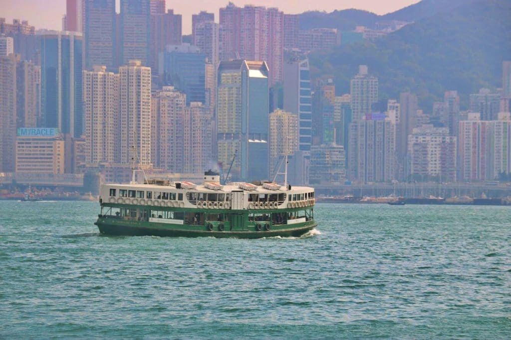 A green and white ferry crosses Hong Kong Harbour