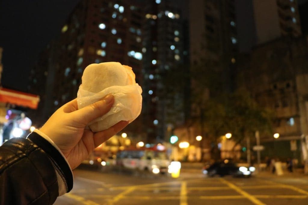 A hand holding up a rice cake