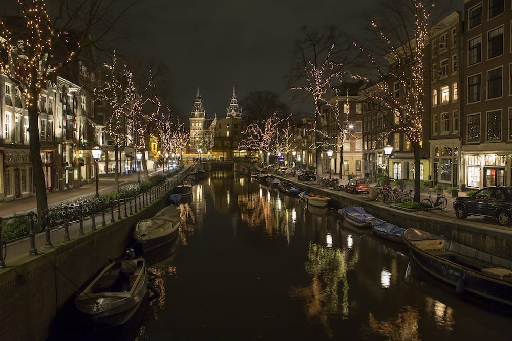 Amsterdam's canals lit up with fairy lights in the trees to celebrate Christmas
