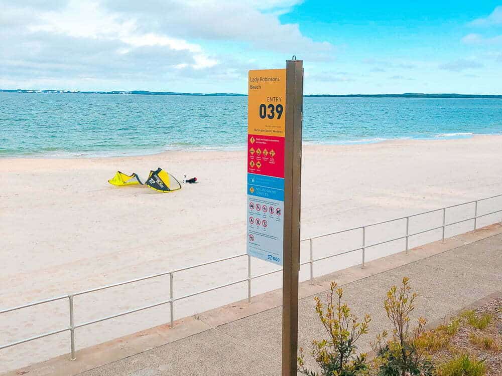 A beach with a kite surfer