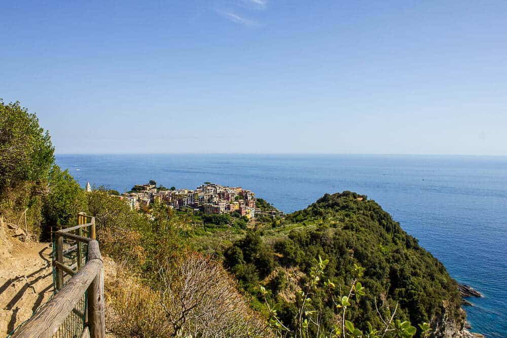 Breathtaking coastal view from a hiking trail on the cliffs of Cinque Terre, Italy, overlooking colourful seaside villages and the Mediterranean Sea.