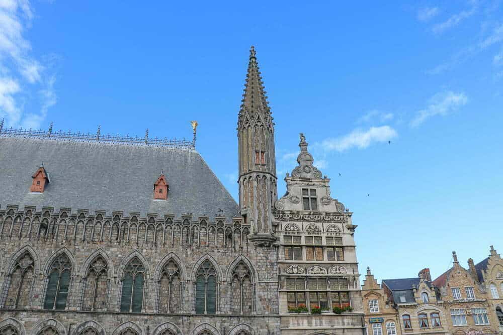 Ancient Gothic cathedral with intricate stone architecture set against a bright blue sky, showcasing historic church design and ornate detailing.