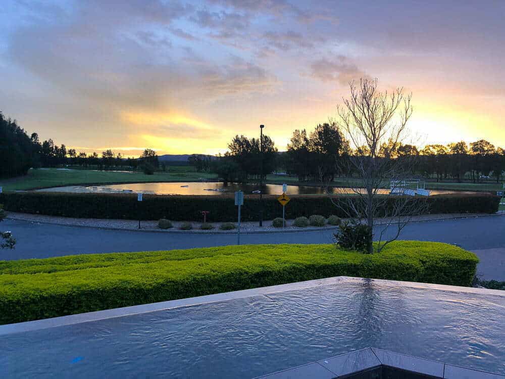 Calyx Golf Club at sunset showing lush green course, water hazards, and scenic natural surroundings in Australia. Perfect for golf enthusiasts and nature lovers.