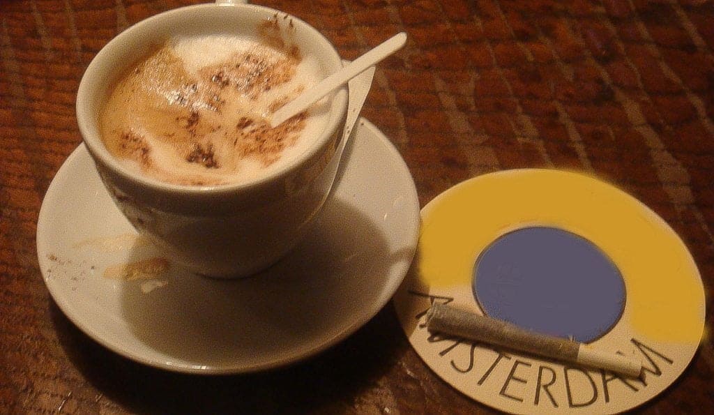 A cup of coffee and a joint on a table