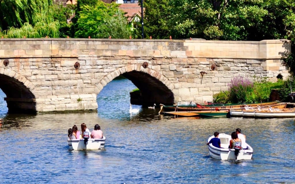 A bridge over Avon River with row boats in the foreground
