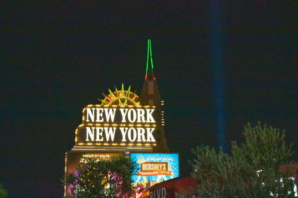 The hotel sign of New York New York lit up against a black night sky