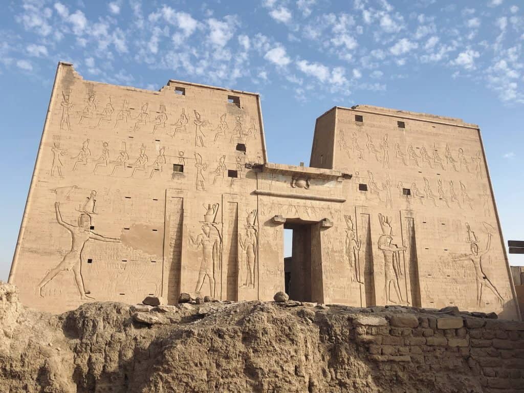 The large carved gates of Edfu with engravings of Egyptian scenes on the walls