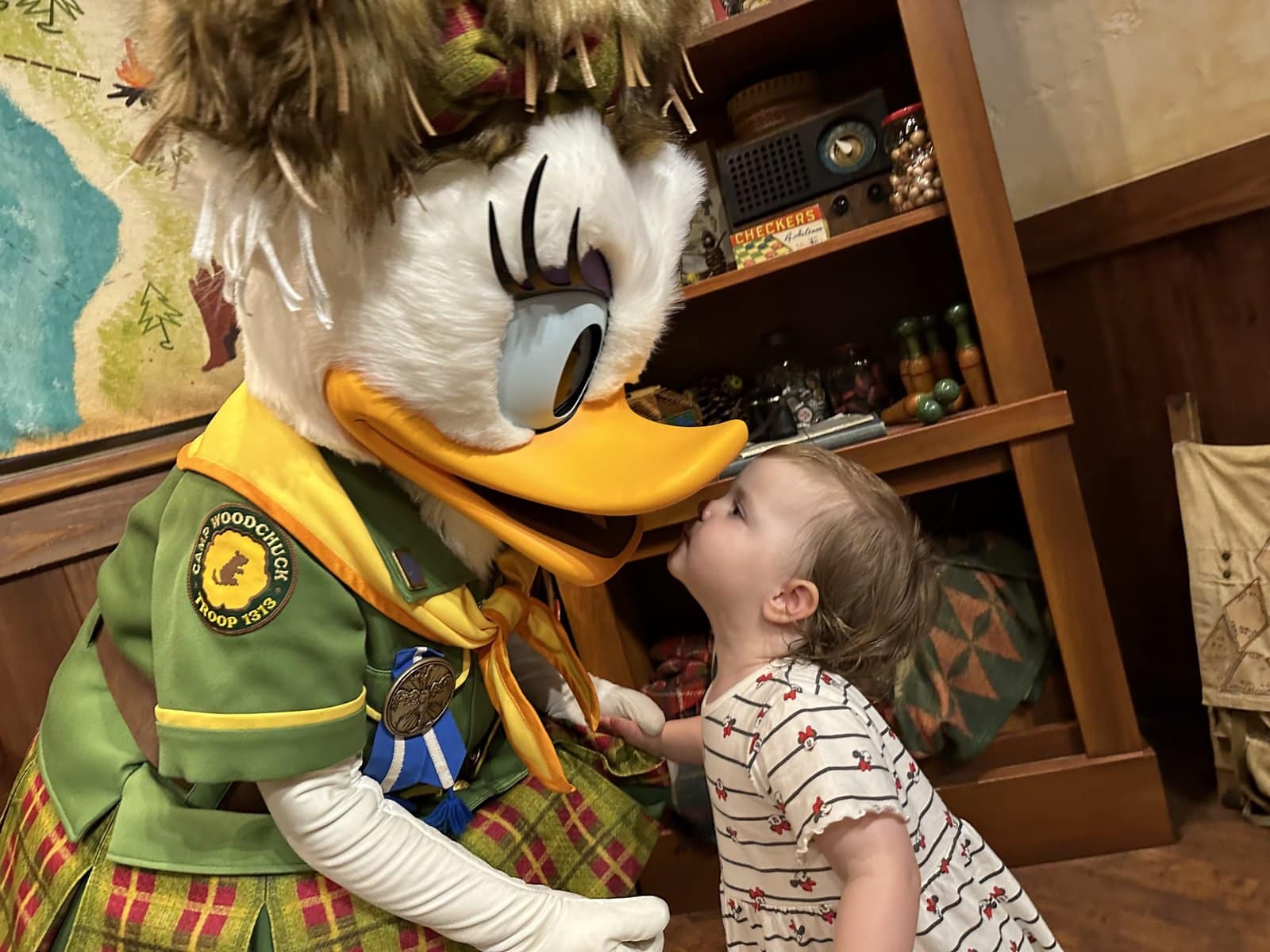 Daisy Duck kissing a toddler at Tokyo Disney