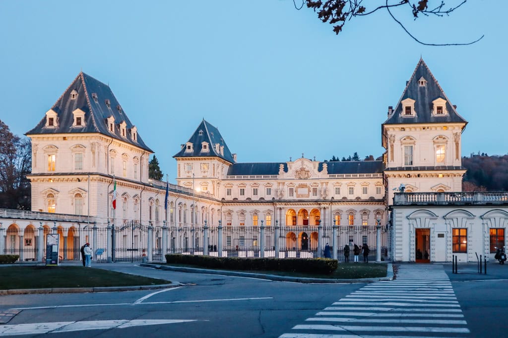 Elegant historic castle illuminated at dusk in Annecy, France, showcasing classic French architecture and charming surroundings.