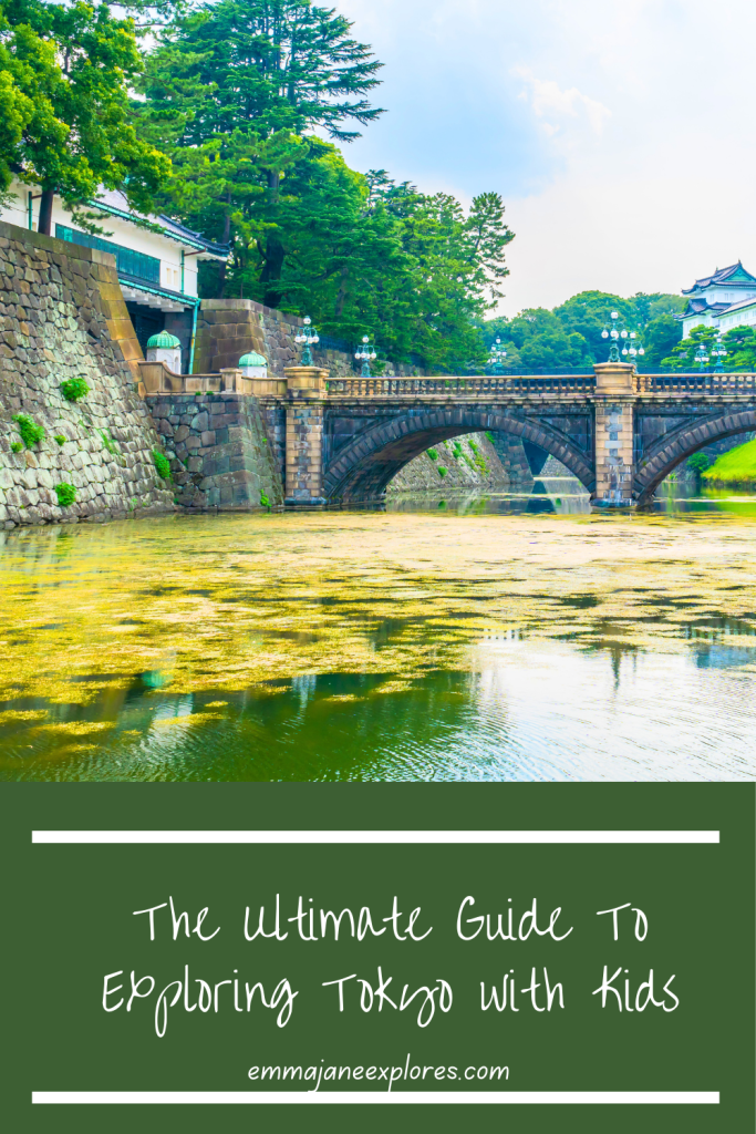 Tokyo river bridge with lush green trees and historic architecture, perfect for family travel and exploration.