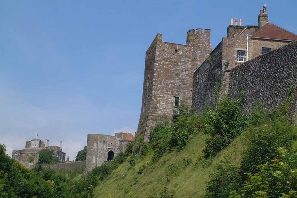 Ancient castle ruins perched on a grassy hillside in the east of England, showcasing medieval architecture and scenic views, ideal for travelers exploring the region's rich history and natural beauty.