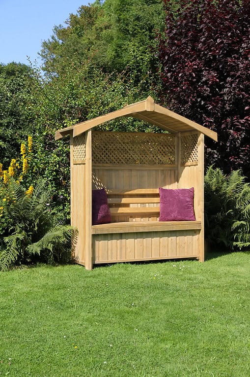 Handcrafted wooden garden gazebo with built-in seating, ideal for outdoor relaxation in a lush green landscape. Perfect for enhancing home garden aesthetics and outdoor living spaces.