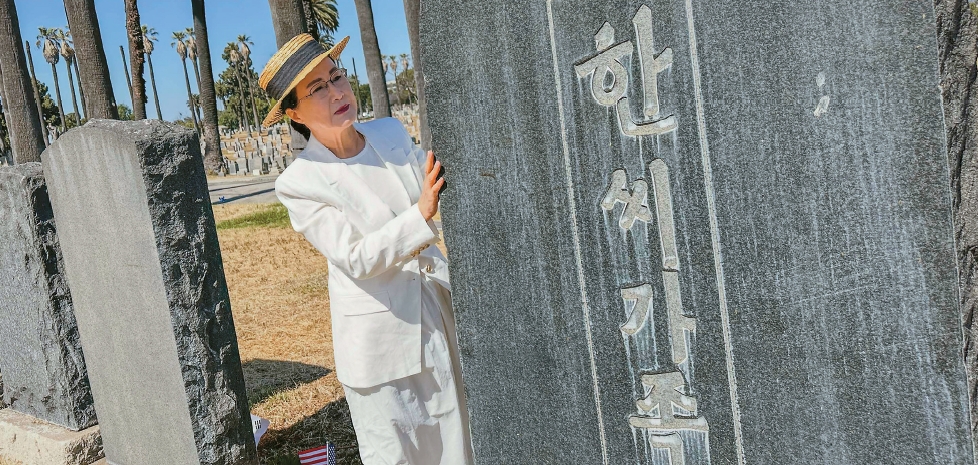 Clara Won examines a Korean American independence activist grave at Rosedale Cemetery