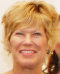 A woman with short, blonde hair smiles at the camera.