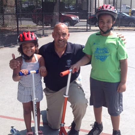 Cambridge Officer Osvaldo Ortiz with Cambridge youth.