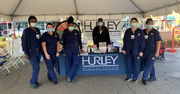 Hurley Medical Center employees at a table at a community event