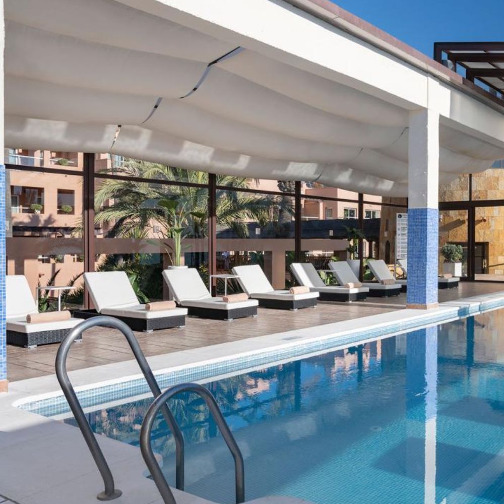 Covered pool with lounge chairs