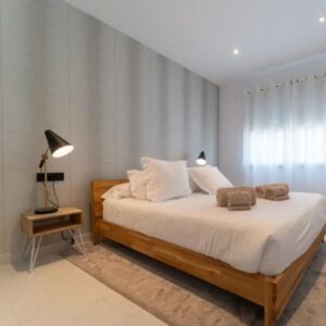 Dormitorio moderno con cama de madera.