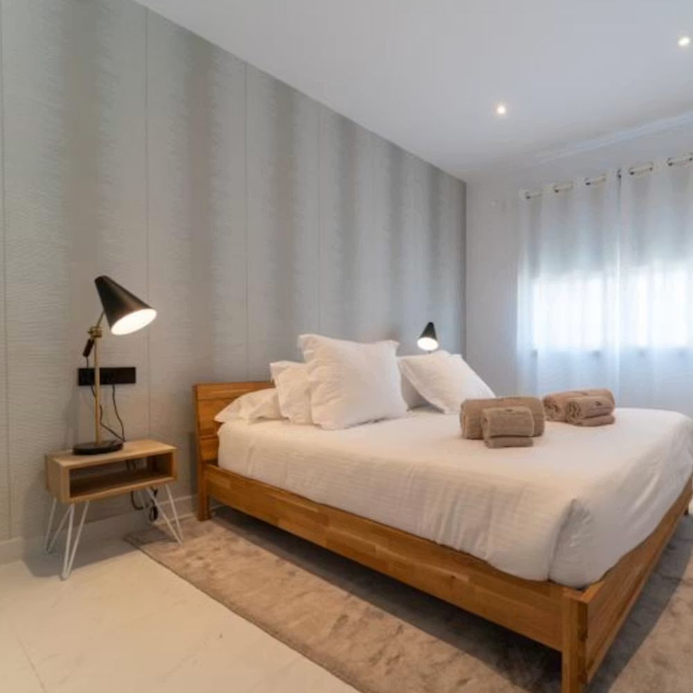 Modern bedroom with wooden bed.