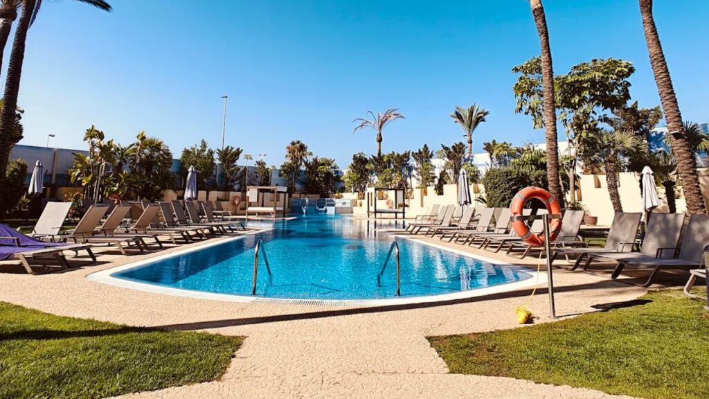 Hotels in Estepona with Swimming Pools Resort swimming pool with lounge chairs.