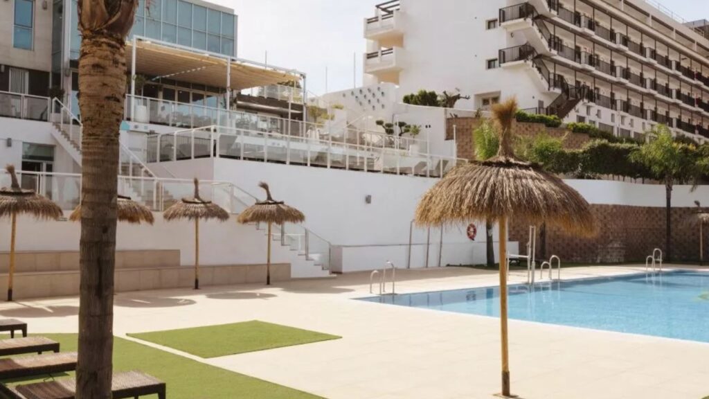 Hotels in Estepona with Swimming Pools Resort pool with thatched umbrellas.