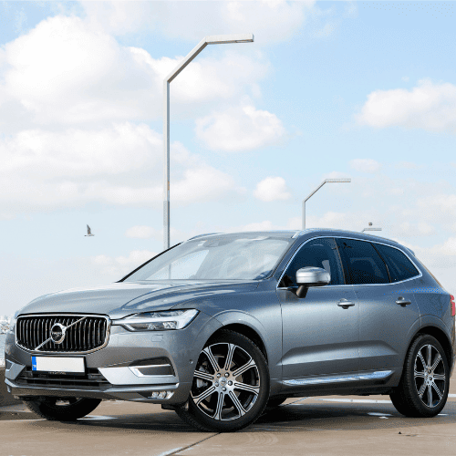 Modern Volvo station wagon parked outdoors, vehicle servicing in progress.