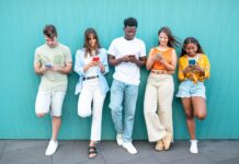 a group of people looking at their cellphones in school