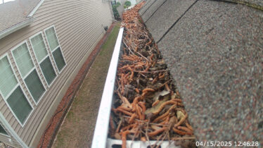 High-resolution close-up of a clean gutter system with leaves and debris removed, ensuring clog prevention.