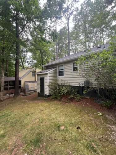 Gutter system preventing clogs on a residential house in Kentucky, surrounded by trees and yard.