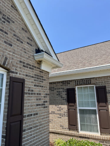 High-quality gutter system preventing clogs on a brick house.