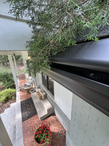 High-quality black gutter system with enhanced clog-free features, installed on a beautiful house in Cincinnati.