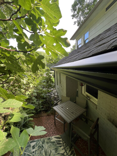 Gutter system installation on house with clean, functioning gutters protecting against clogs.